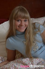 Sweet Smiling Young Blonde Coed On The Bed